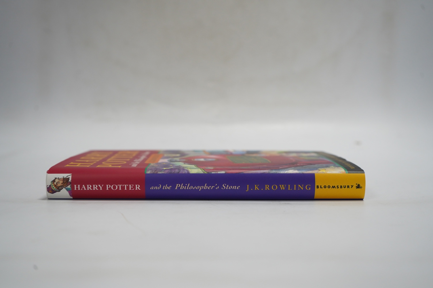 Rowling, J. K. - Harry Potter and the Philosopher's Stone. First Edition (reprinted). armorial half and title pages. publisher's coloured pictorial boards and d/wrapper. Bloomsbury, (?1999)